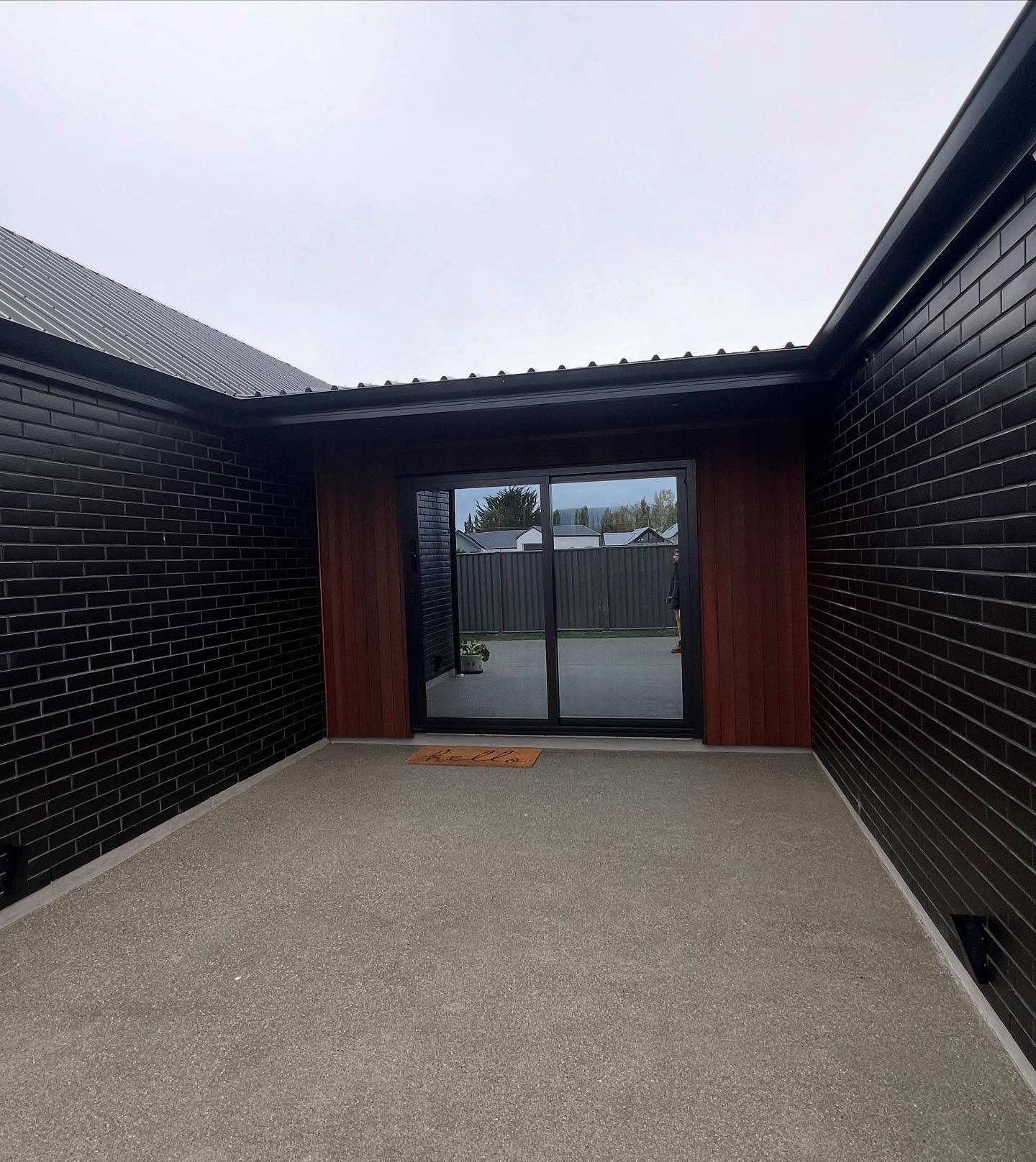 Modern black brick and glass entrance